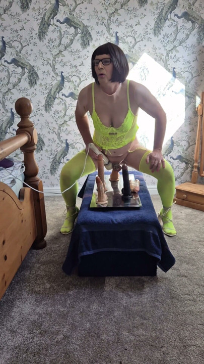Sexy Mature Crossdressing Sissy Slut in yellow lingerie and limp dick in chastity rides some of her dildos | Clip 2