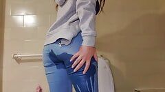 Girl with great ass pees in her jean pants and plays with her wet pussy