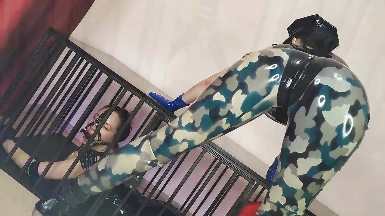Latex Officer Fucks His Latex Prisoner with a Strap-on