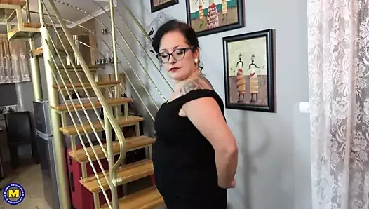 Stylish mature wife fucks her pussy near fireplace