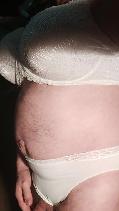 I'm wearing a white dress, a bra, and beautiful lace panties.