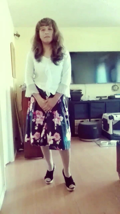 Jhazmeena wearing a white blouse and a vintage black flower print skirt.
