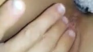 Girl fingers her pussy