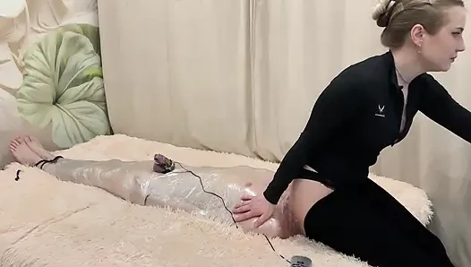The Head Is in the Pants of the Mistress, the Slave Receives Electric Shocks and Tries to Breathe