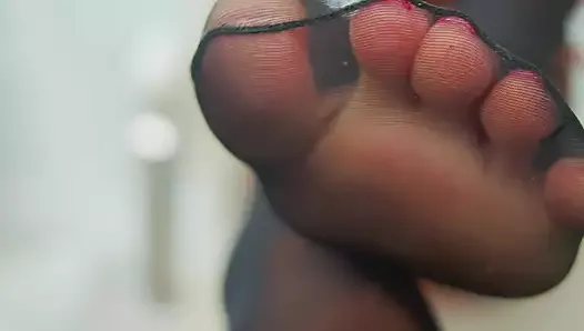 feet in pantyhose and saliva close-up