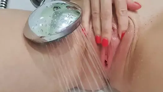 MILF caresses a big clitoris in the shower and gets a sweet orgasm