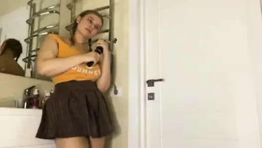 A chubby girl in a college skirt fucks herself