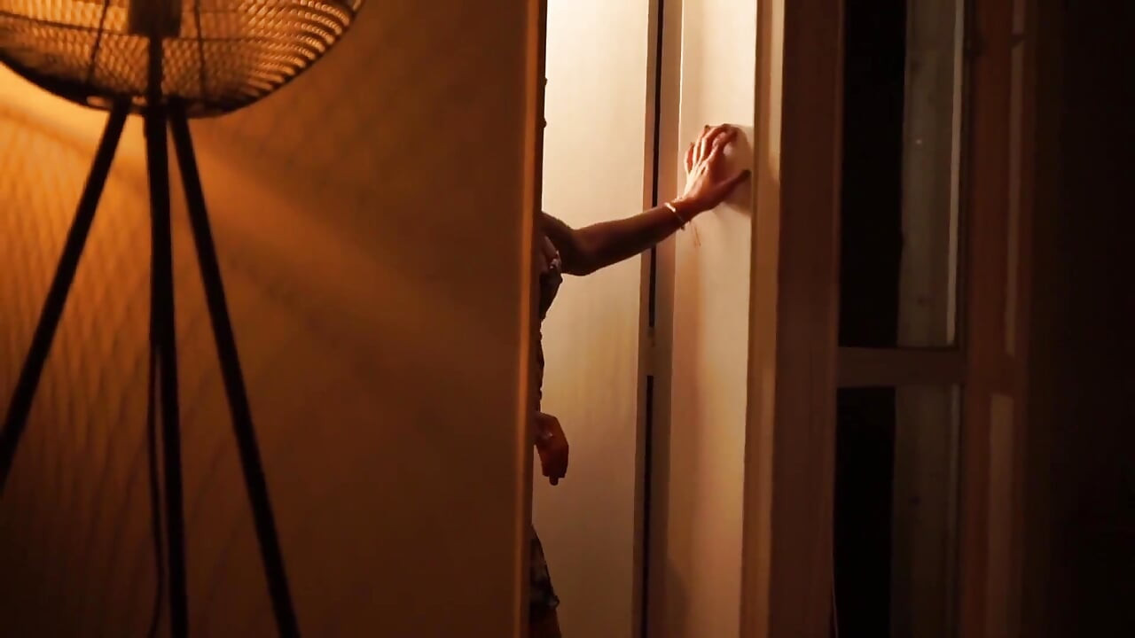 Sensual Latina Doing a Striptease in Low Light
