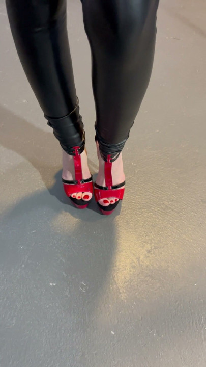 Black vinyl leggings in red stiletto heel.