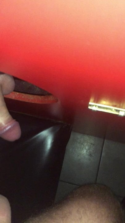 Playing with a cock at the gloryhole