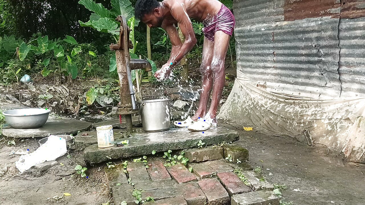 Black mature man bath in desi style. Showing big dick.