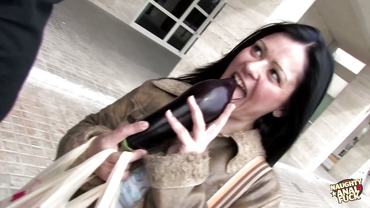 A woman displays her breasts and engages in anal intercourse with a large penis.