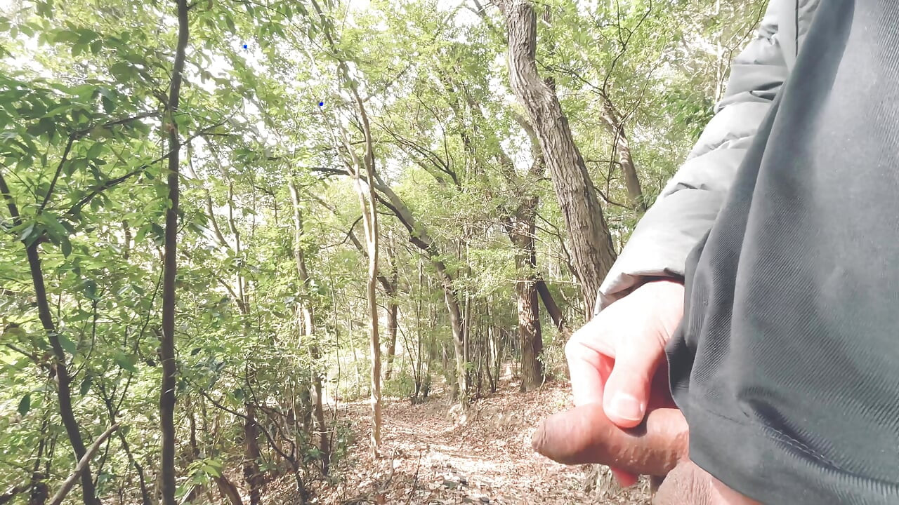 A boy with a small foreskin pees a huge stream outdoors