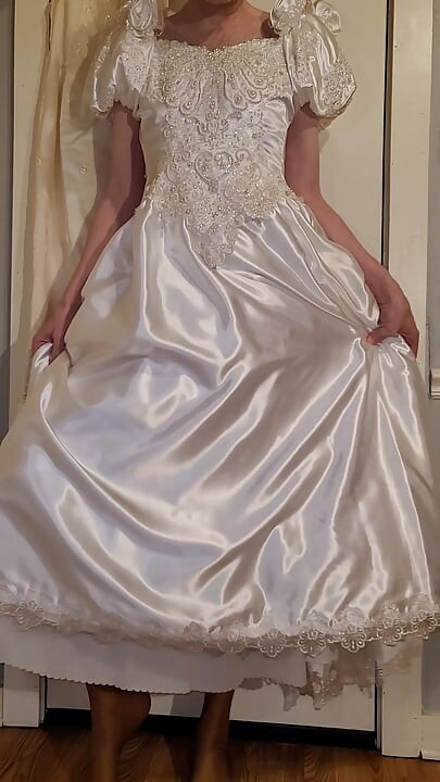 Trying on a liquid satin wedding dress.