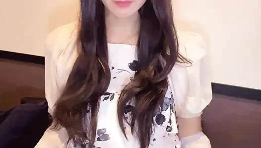 A video of a curly-haired crossdresser quietly masturbating.