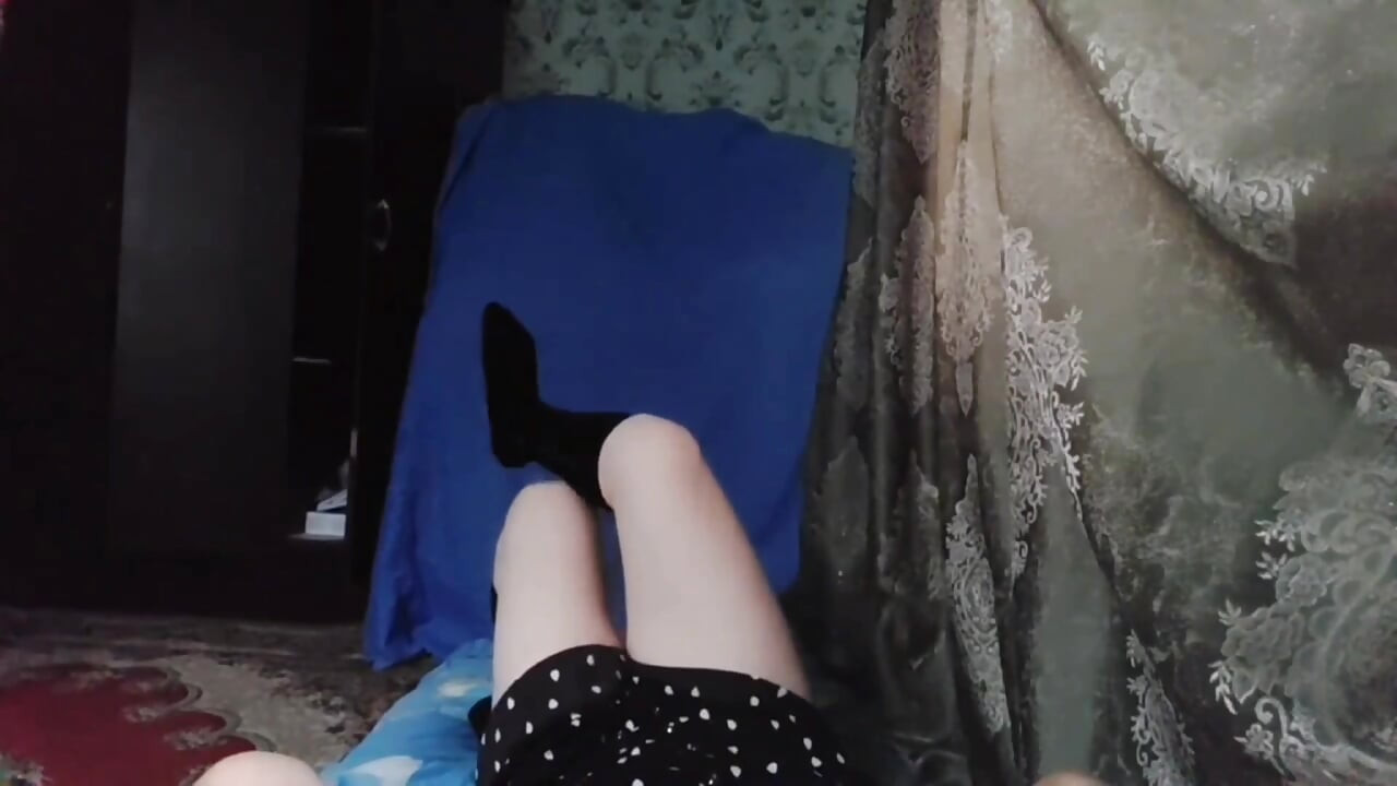Lovely femboy in plaid skirt skipping down street