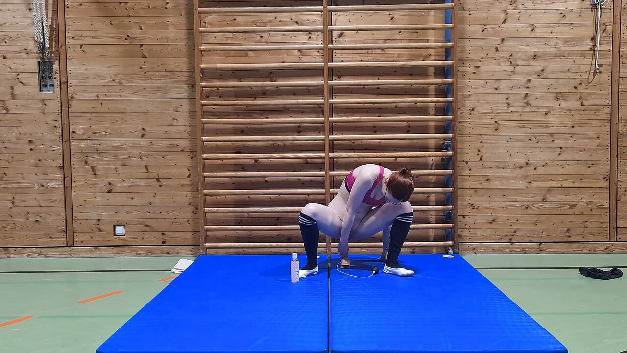 Kinky girl fucks a dildo in the school gym