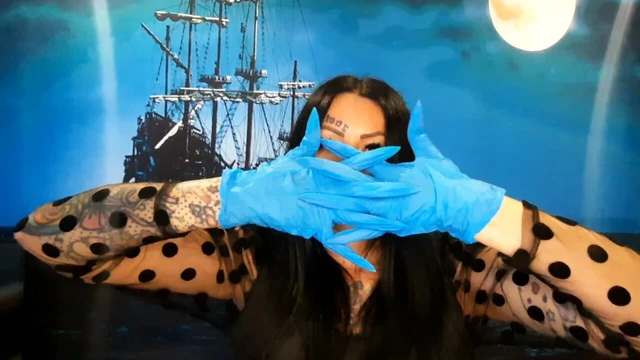 Glove fetish. Dominatrix Nika puts on medical gloves and tears them with her long nails. Latex gloves