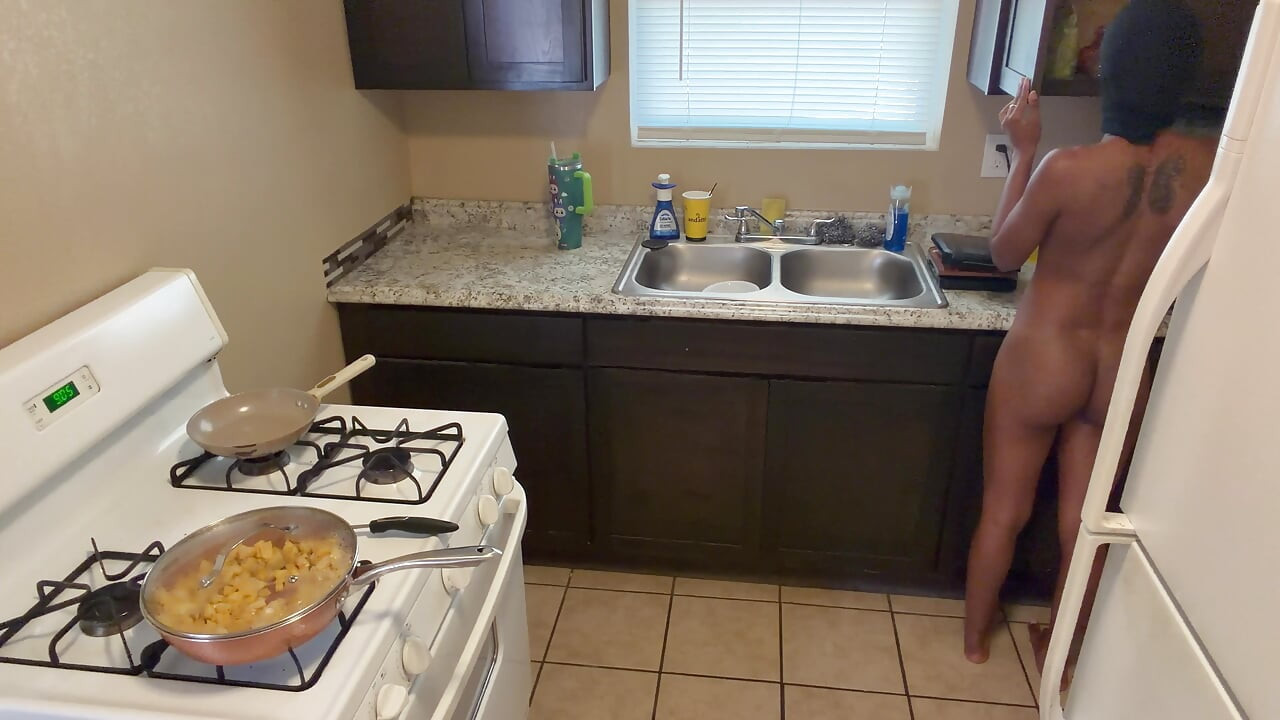In the kitchen cooking and preparing food booty naked!