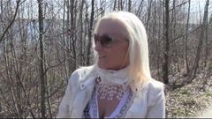 Blonde big tit MILF give blowjob in woods