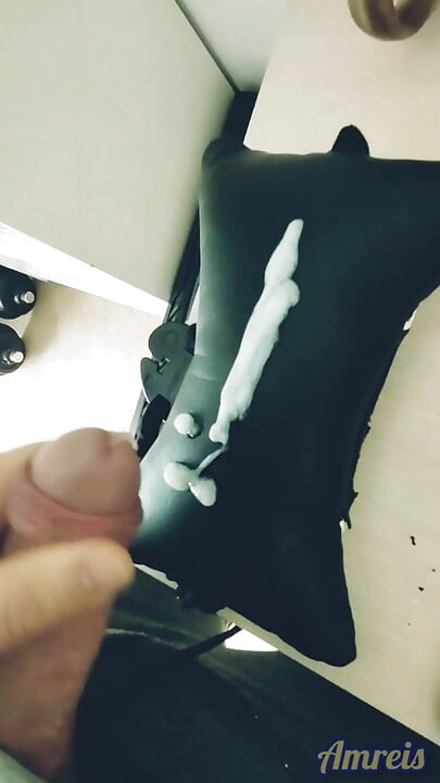Jerking off in a gaming chair and orgasming on a gaming pillow.