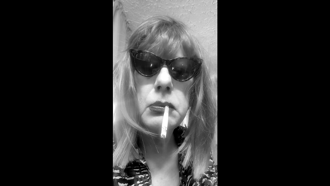 MRS. ROMAN DESTROYING A MARLBORO 100 MENTHOL CLOSE UP - WITH DANGLING AND NOSTRIL EXHALES