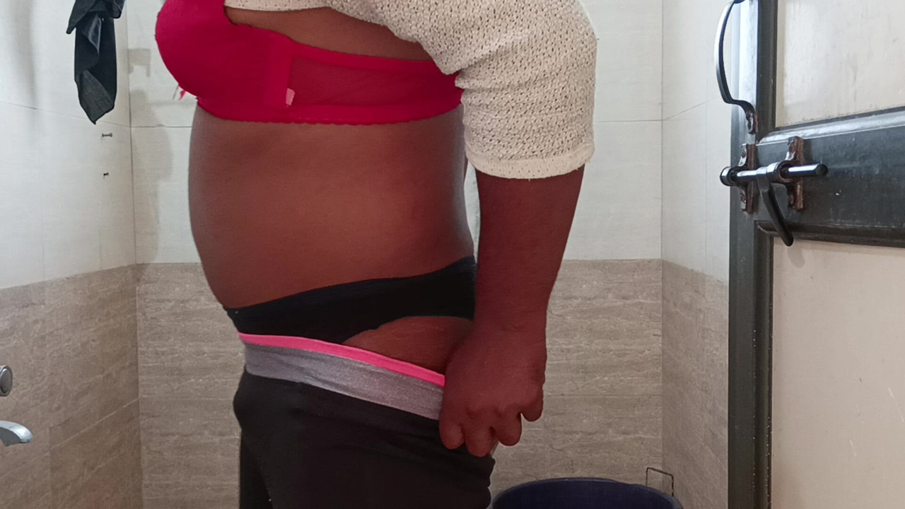 Indian boy wearing bra and panties in batharoom.
