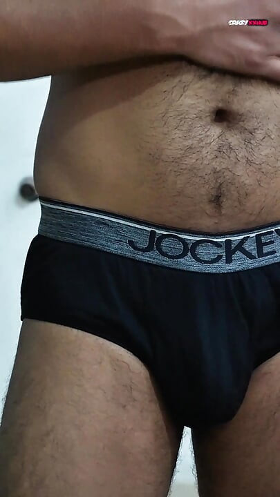 A sexy guy is dancing while holding his cock.