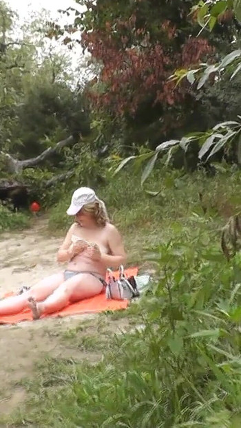 Memorable moment from "Wild beach. Random passerby guy peeps on sunbathing topless beautiful Milf on the river bank"