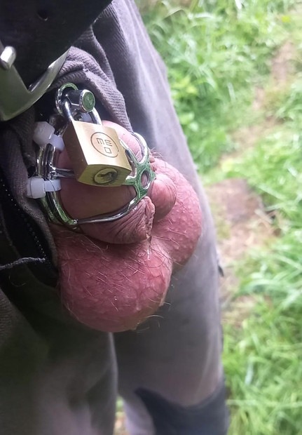 Cuckold with helpless small cock and chastity cage pisses outdoors