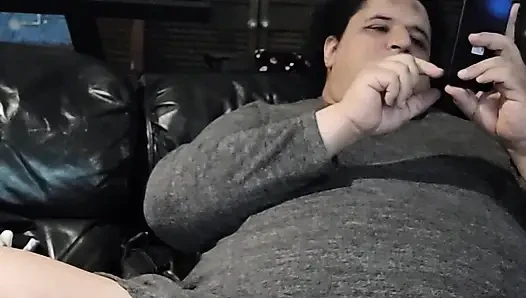 Bored fat trans playing on couch