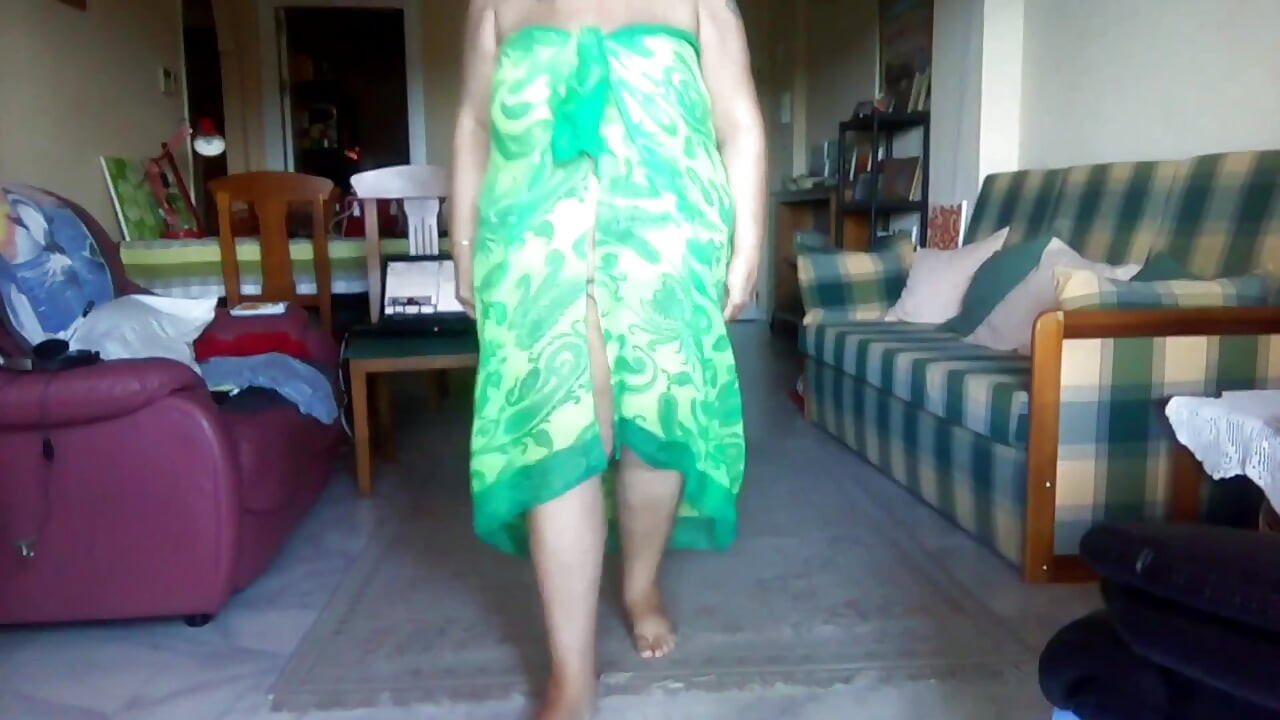 Jen is standing up and is peeing on a towel on the floor