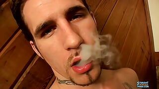 Chain smokes on one hand and strokes his cock on the other