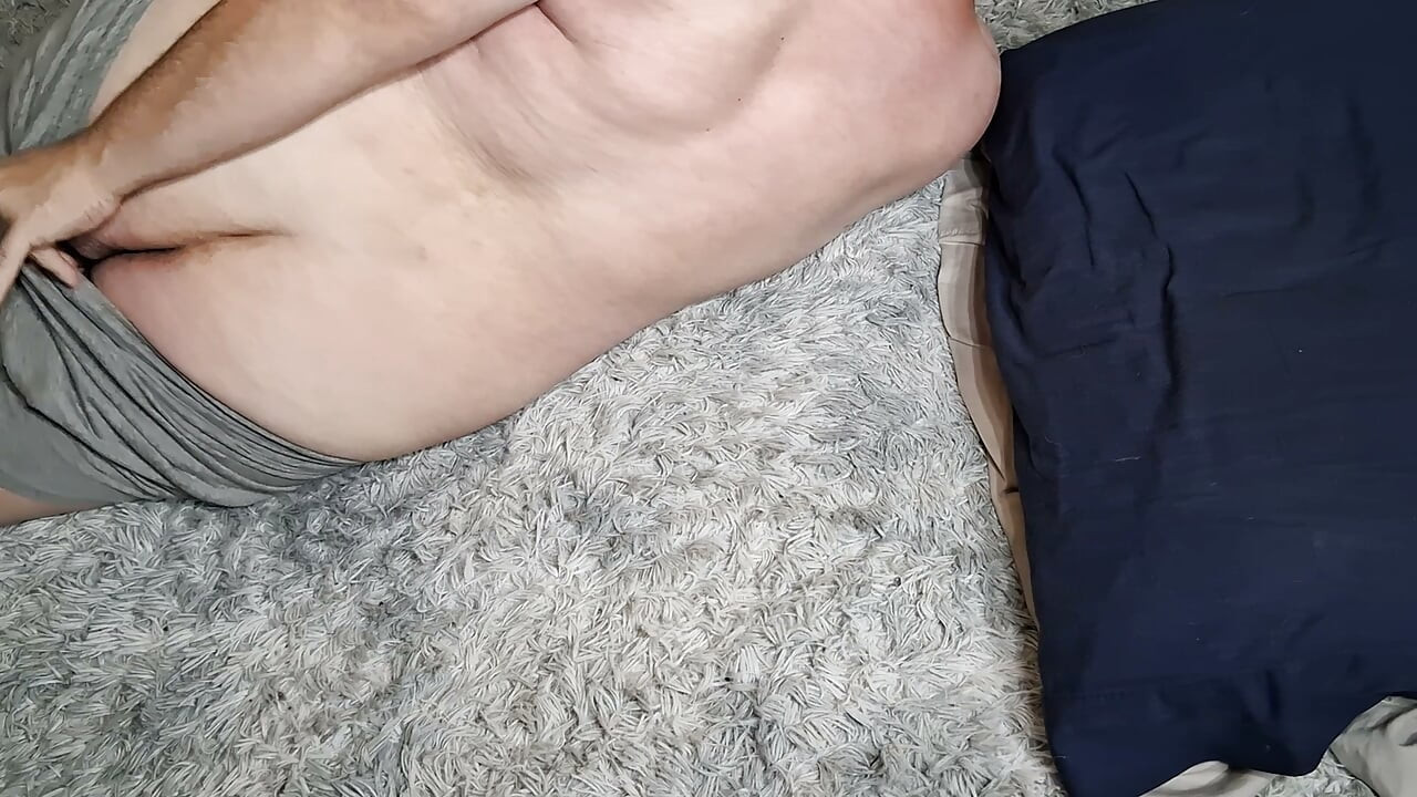 Chubby guy lays on floor and cums