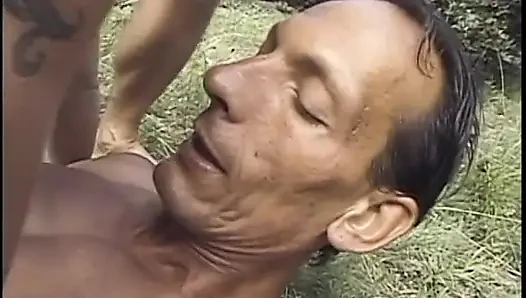 Bisexual stud gets his ass fucked by a dude while fucking a brunette babe on the grass