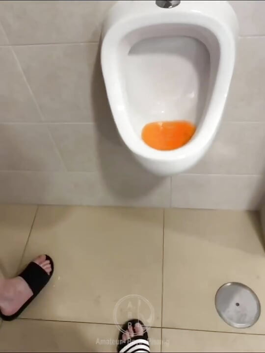 Filming the Guy Peeing Next to Me at the Urinal of the Pool Toilets