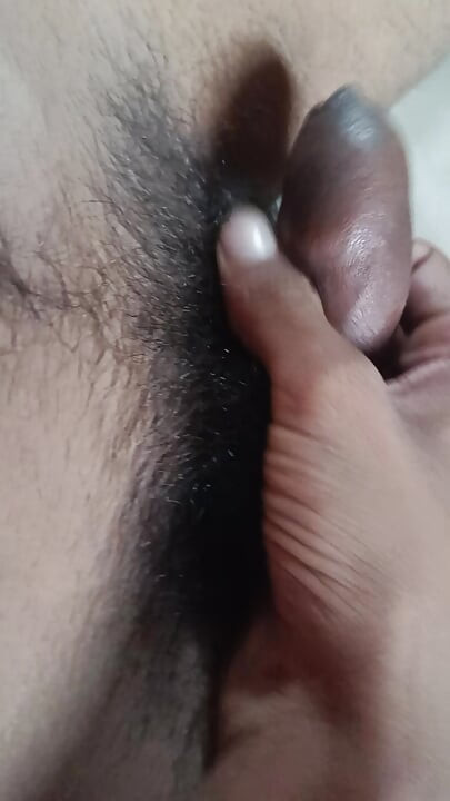 The boy is shaking his penis in his hand and ejaculating.