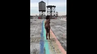 Black woman naked on the rooftop