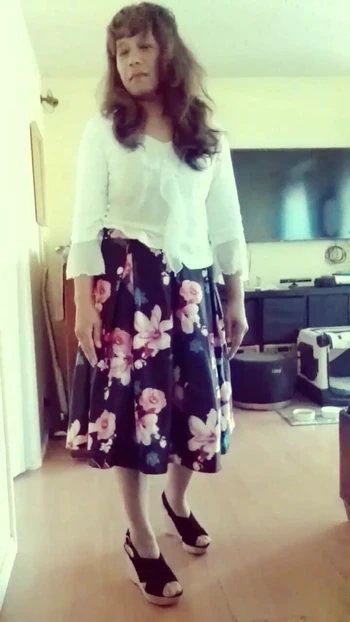 Jhazmeena wearing a white blouse and a vintage black flower print skirt.