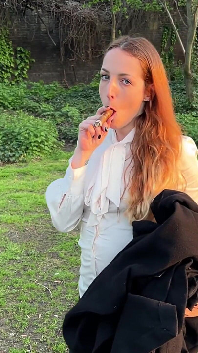 Liz Rainbow Smoking a Flor De Oliva Cigar Outdoors