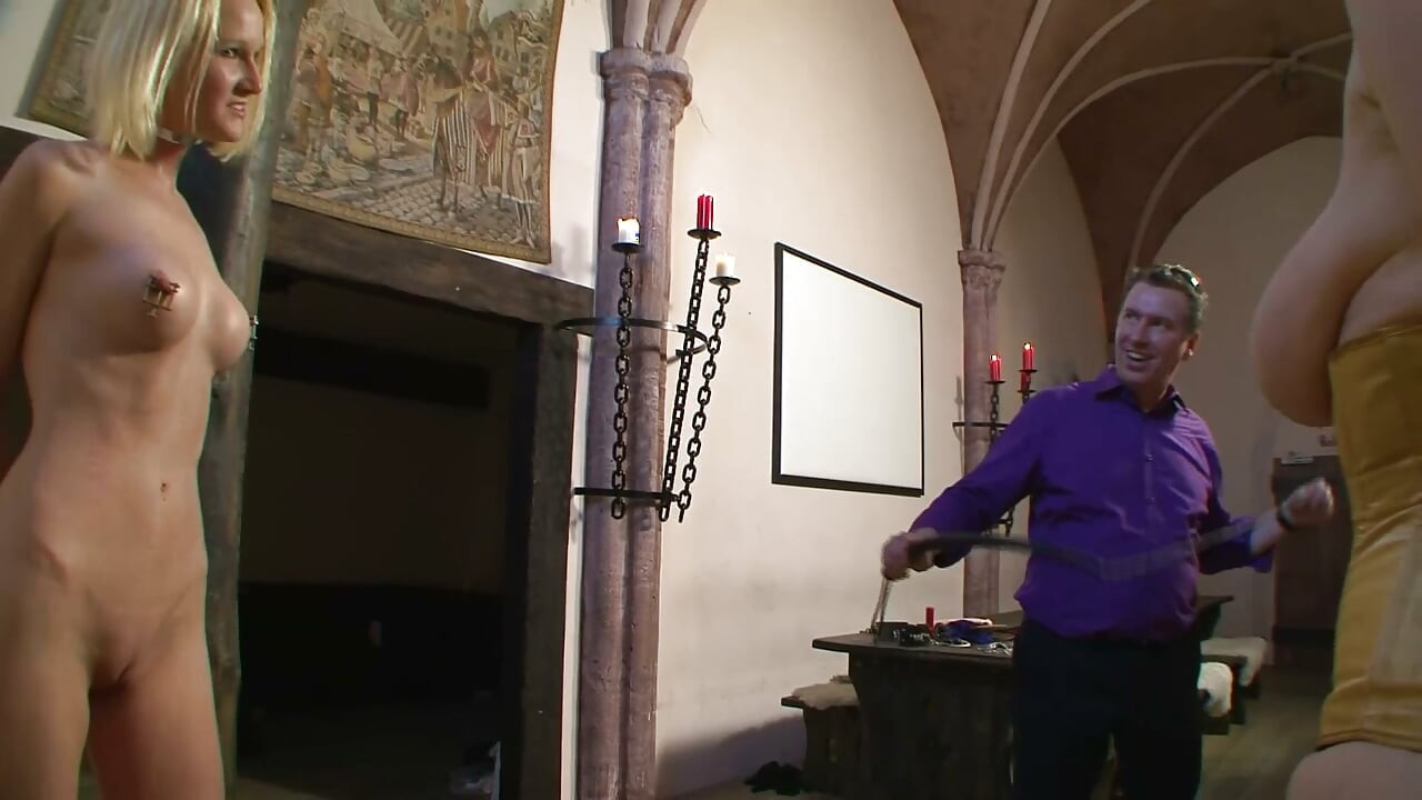 Master Whips His Chained Blonde Slaves in the Dungeon