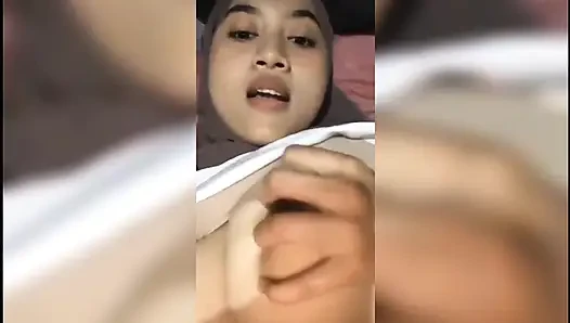 Beautiful girl who is squeezing her breasts alone