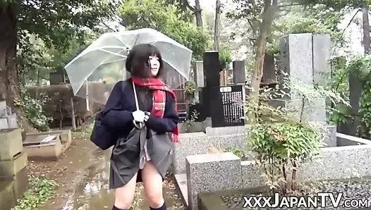 Cute Japanese chick has vibrator pleasing her in the rain