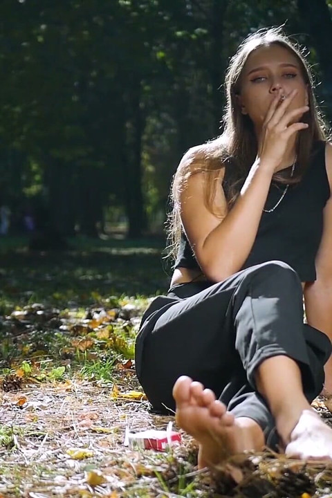 Seductive Russian Beauty Smoking Cigarette in Studio