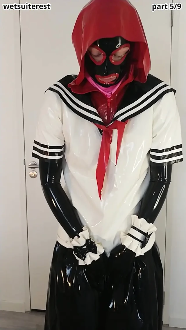 Putting on latex Japanese schoolgirl sailor uniform and long gloves over rubber dress, long skirt and corset, layers