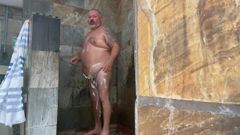 Daddy sneaks off to jack off in the showers at camp site