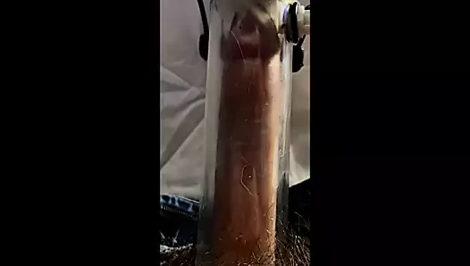 Milking machine sucks and stretches cock