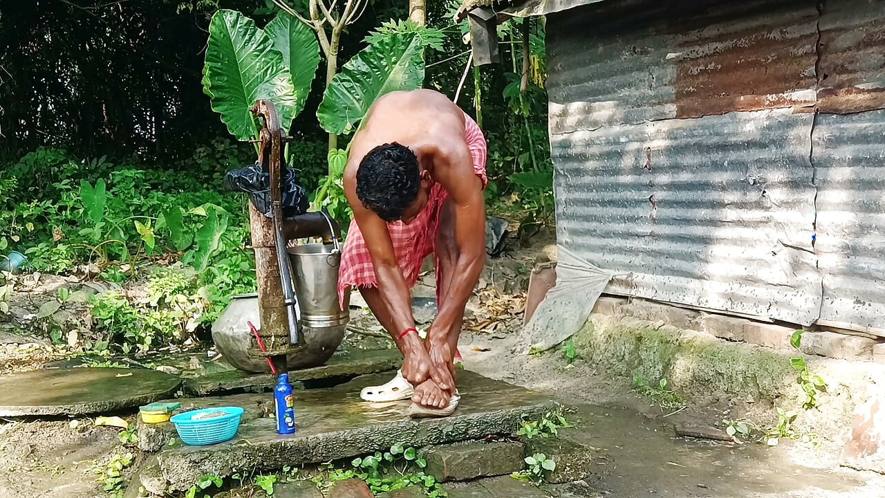Desi young man bath Open place.