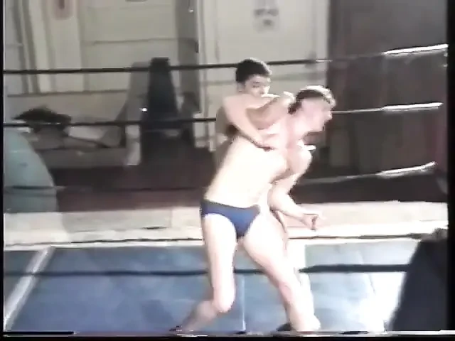 Two young men wrestle close in ring