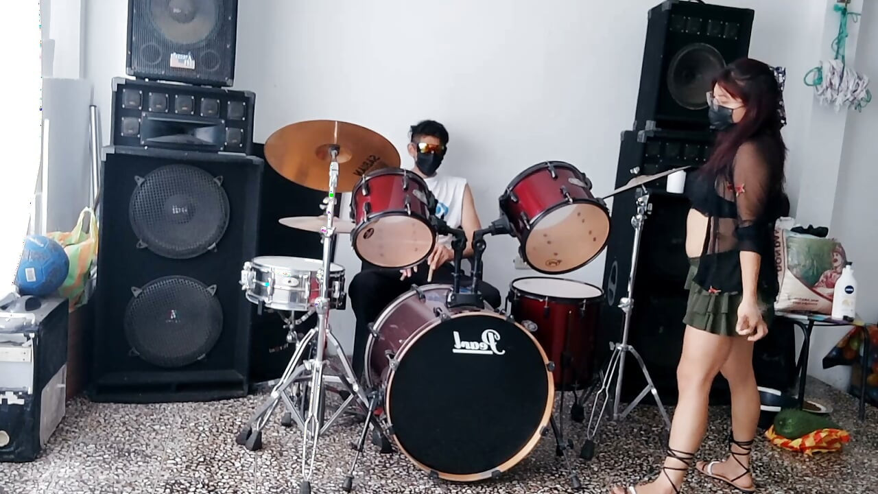Best female friend performs a sexy dance for her male friend while he plays the drums.